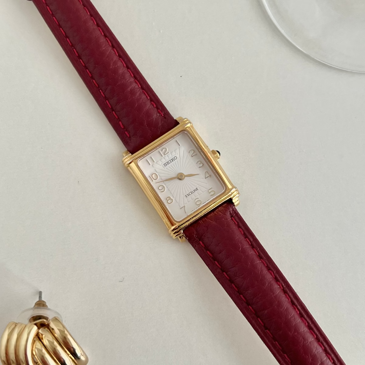 Seiko Exceline square gold tone women’s watch with pale radial textured dial and burgundy leather strap