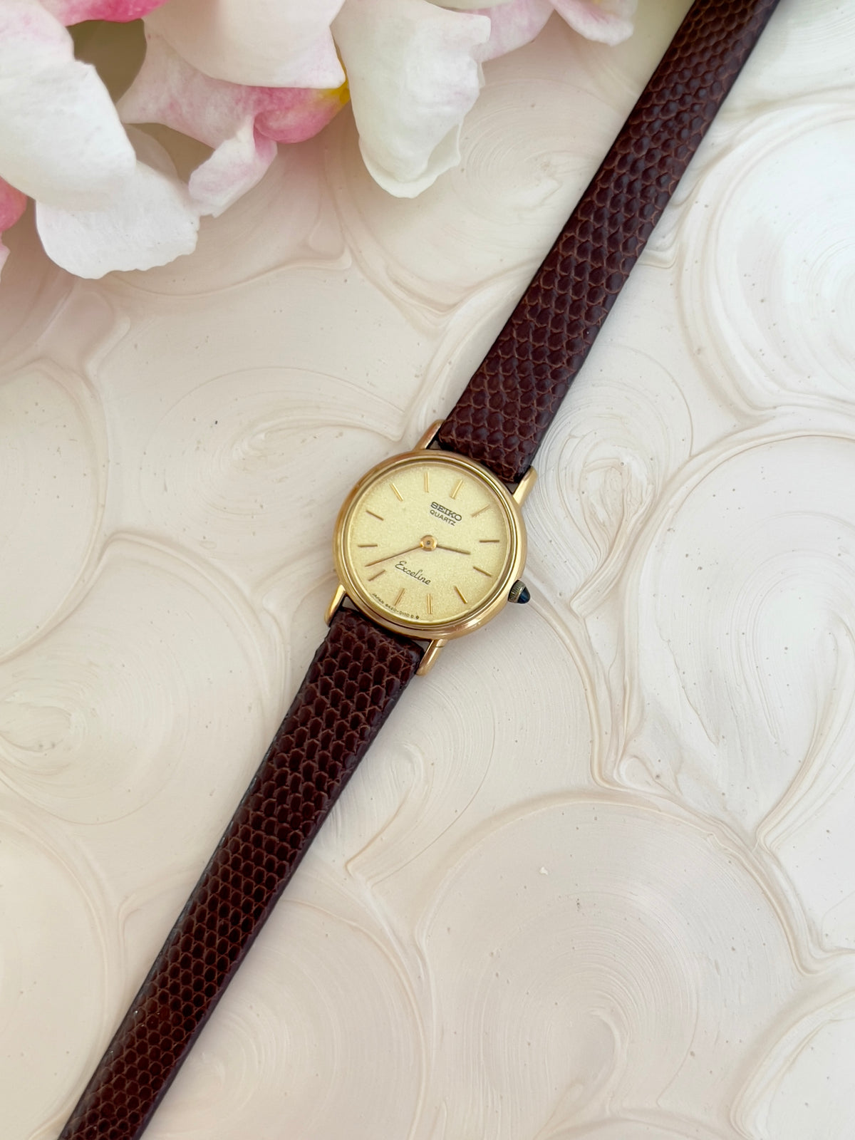 Caseback detail of the Seiko Exceline gold-tone watch.