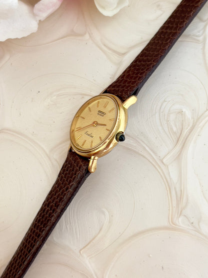 Front view of the Seiko Exceline gold-tone watch with champagne stardust dial.