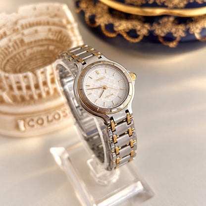 Close view of the Seiko Exceline lattice dial, polished and textured bezel panels, and brushed two tone bracelet.