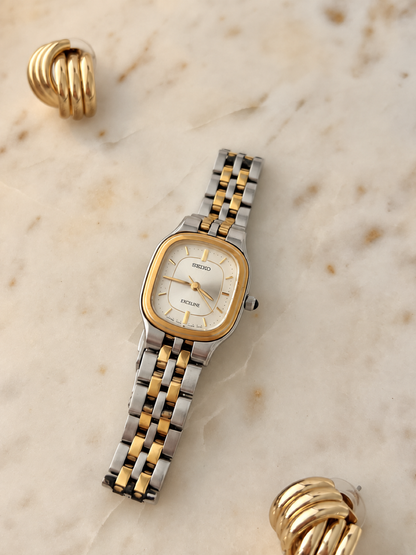 Seiko Exceline two tone watch angled view showing silver dial and articulated bracelet, softly gilded colour balance