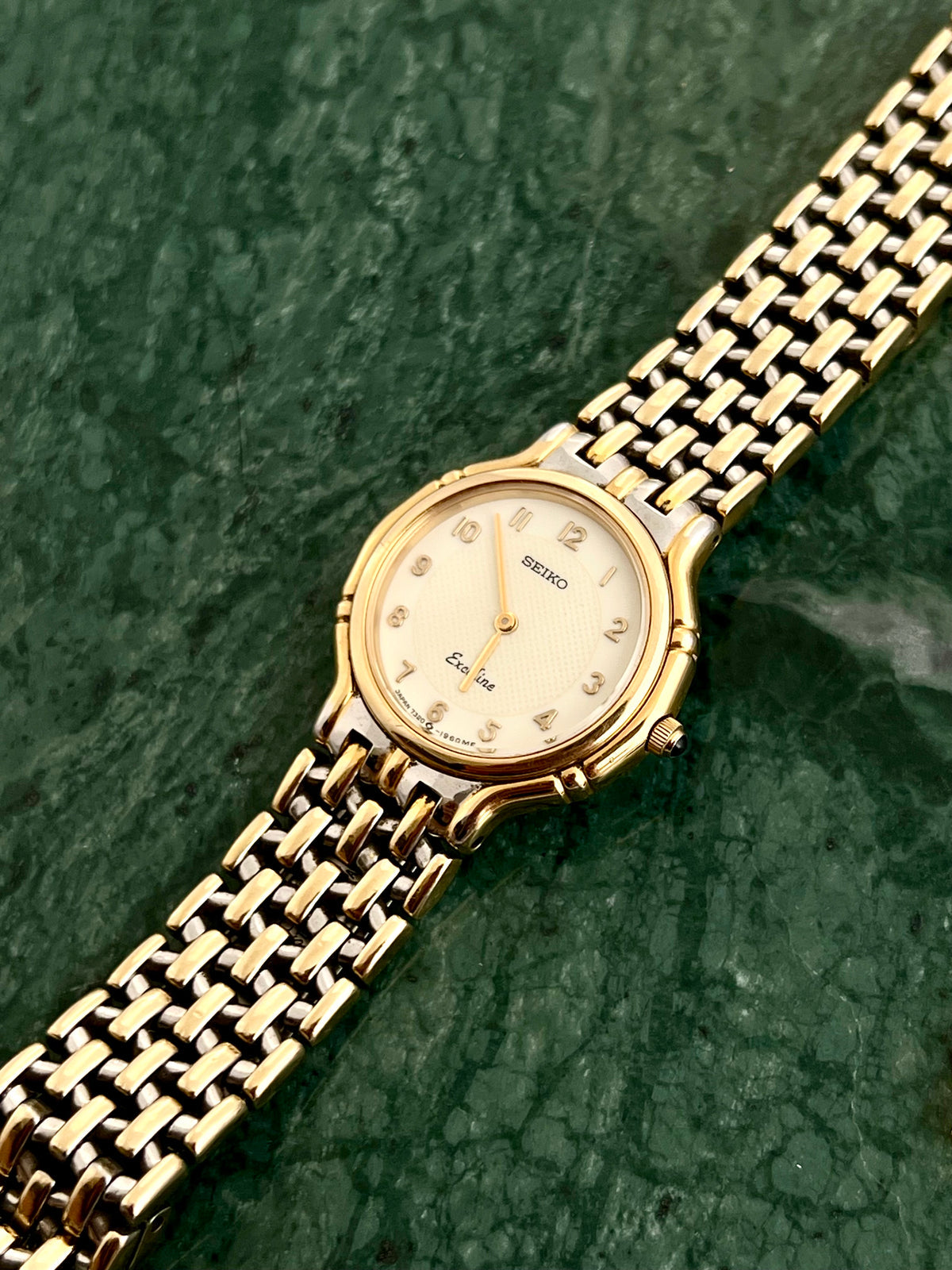 Angled view of the Seiko Exceline round two-tone case and bracelet.