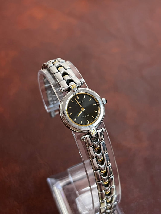 Seiko Exceline Watch with Black Dial featuring black dial and steel bracelet; vintage watch product image 1.