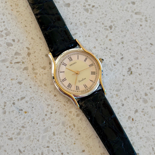 Seiko Exceline Two Tone Woman's Watch with Salmon & Cream Dial — watch face and case shown from the front.