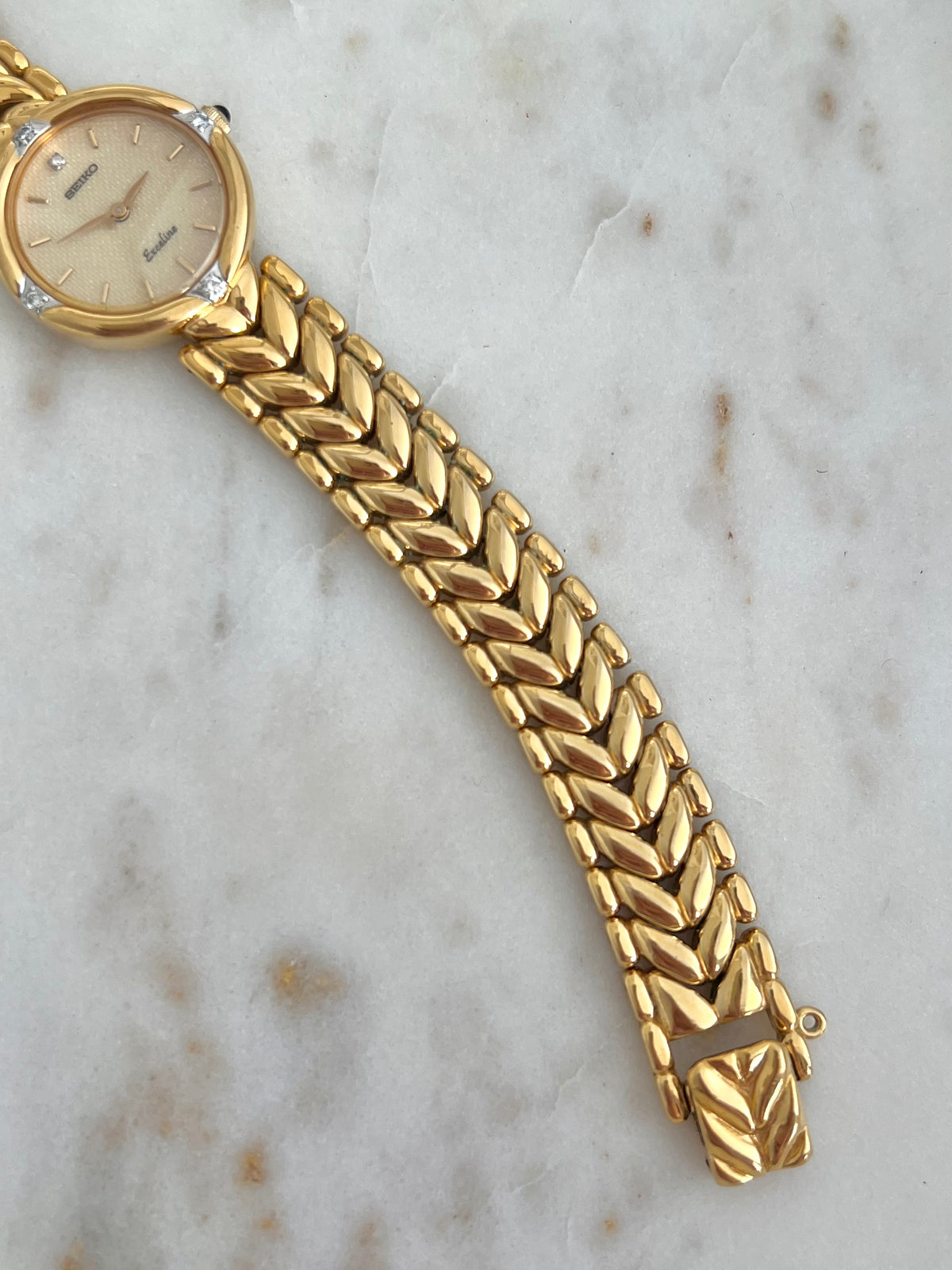 Seiko Exceline Woman's Watch with Diamonds and Sculpted Pattern Bracelet, angled view of a vintage women's watch at Gilded Hour.