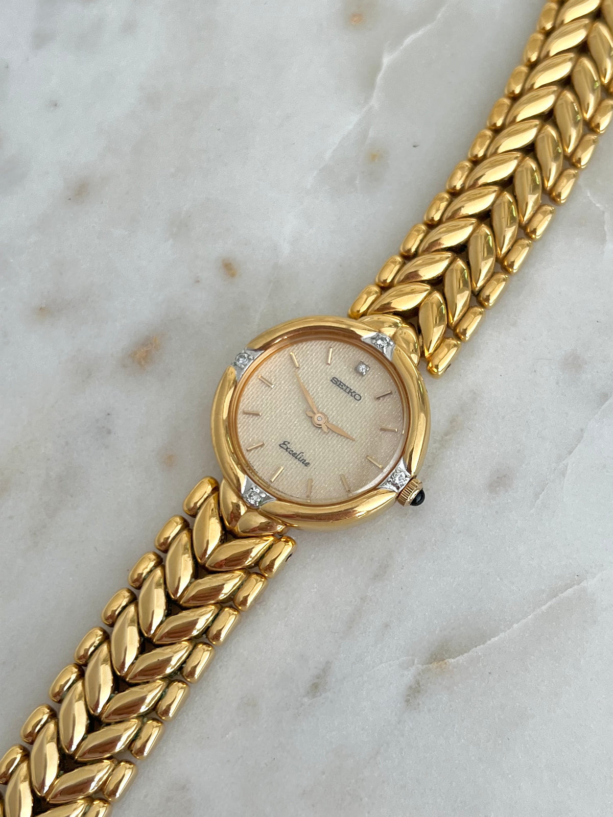 Seiko Exceline Woman's Watch with Diamonds and Sculpted Pattern Bracelet, case profile of a vintage women's watch at Gilded Hour.
