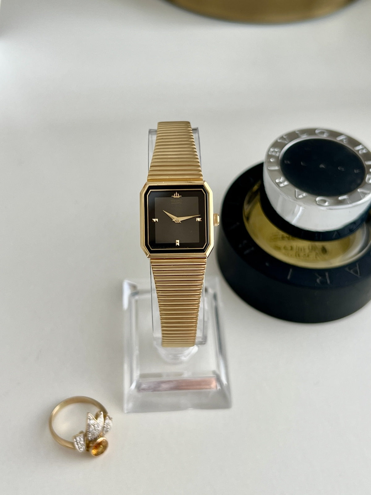 Seiko Galaxy women’s watch with a black panel dial, angular gold tone case and ribbed bracelet, shown front on.