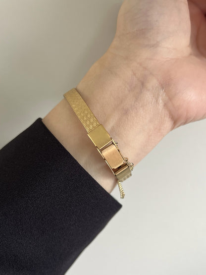 Gold tone folding clasp and fine safety chain on the underside of the Seiko Galaxy bracelet.