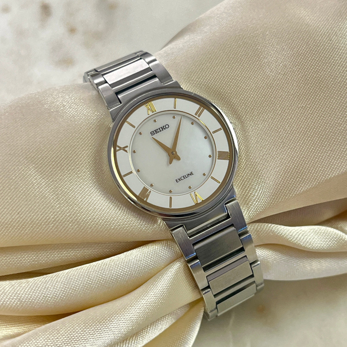 Seiko Exceline Mother of Pearl Silver Bracelet Women’s Watch; integrated silver tone bracelet with brushed and polished links. Product photograph 1 of 9.