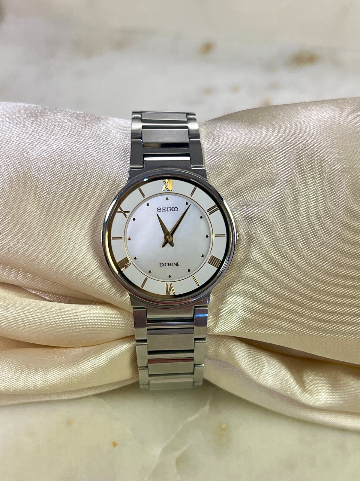 Seiko Exceline Mother of Pearl Silver Bracelet Women’s Watch; integrated silver tone bracelet with brushed and polished links. Product photograph 7 of 9.