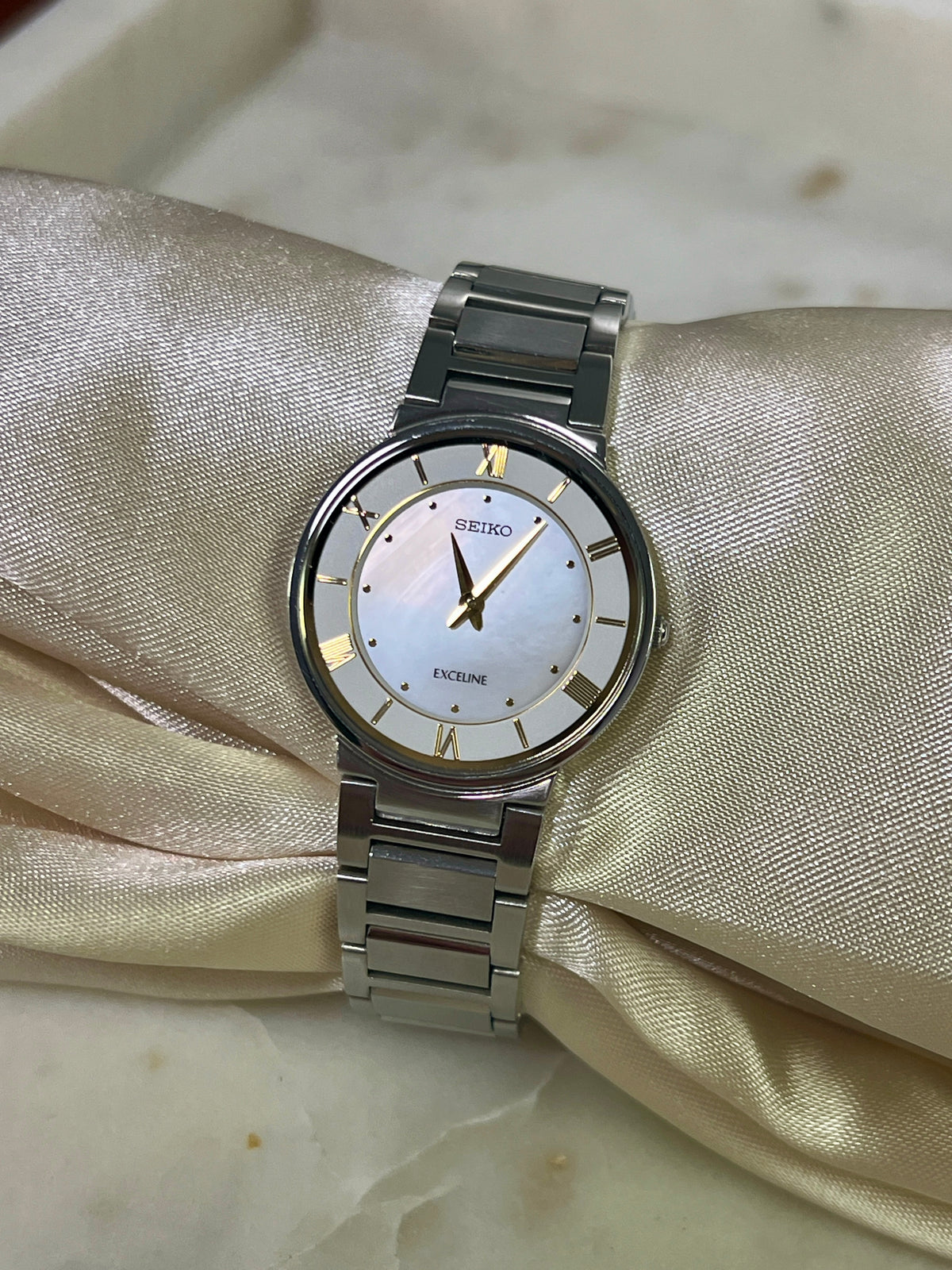 Seiko Exceline Mother of Pearl Silver Bracelet Women’s Watch; integrated silver tone bracelet with brushed and polished links. Product photograph 9 of 9.