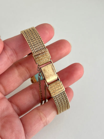 Seiko gold tone five row bracelet with patterned folding clasp and safety chain