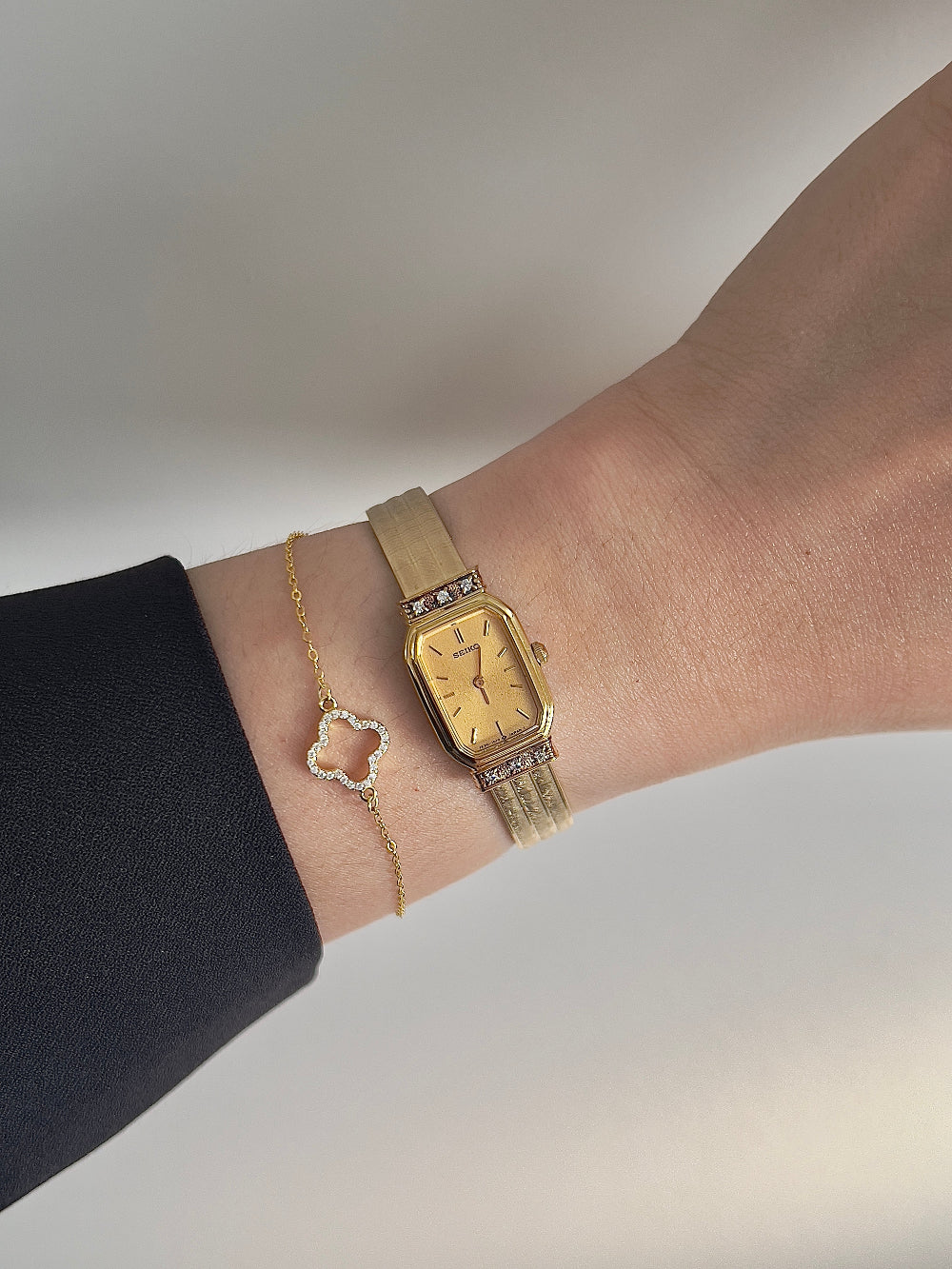 Angled view of the Seiko gold-tone rectangular case and integrated bracelet.