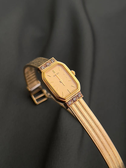 Detail of the Seiko gold-tone dial and crystal-accented rectangular case.