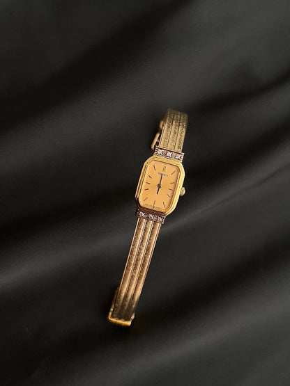 Front view of the Seiko champagne dial and crystal-accented gold case.