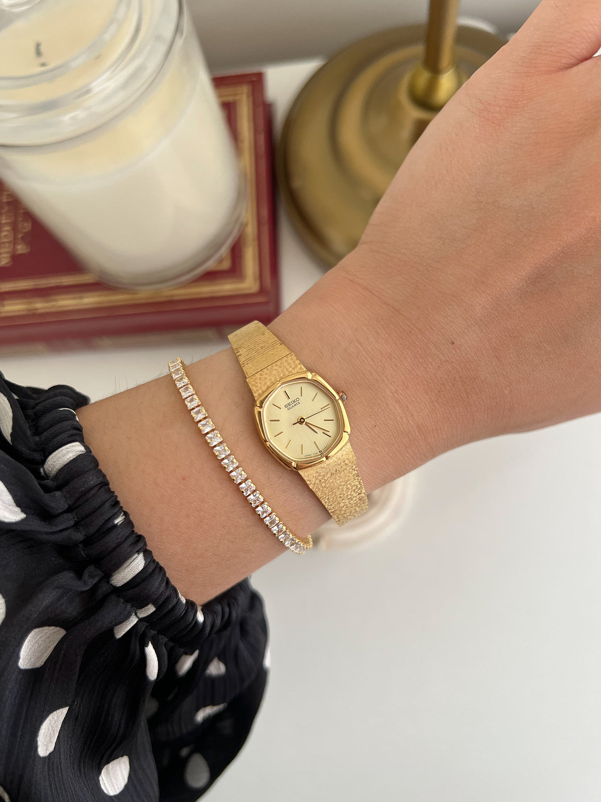 Seiko Gold Cushion Tatami Bracelet Women’s Watch — Worn on the wrist with a gold bracelet