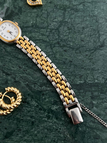 Seiko gold oval bracelet watch shown on a wrist.
