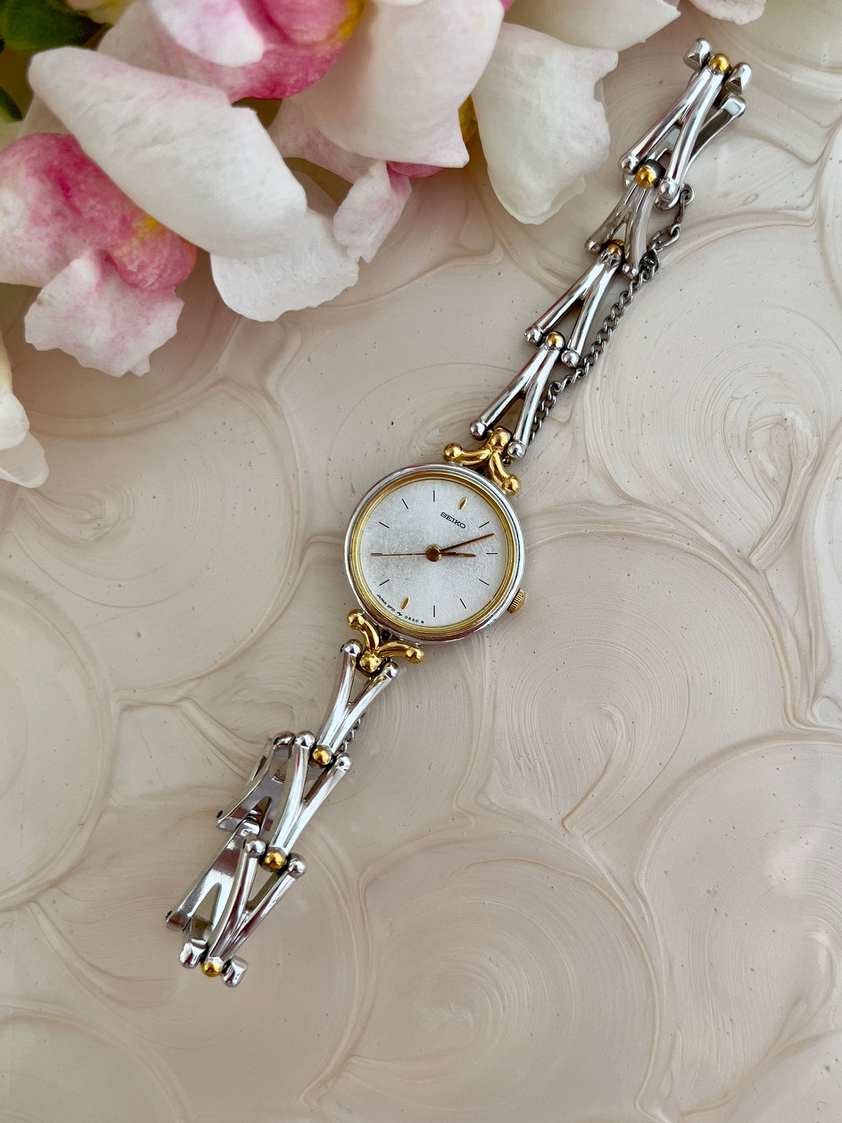 Seiko Two Tone Women’s Watch with White Dial and Sculpted Bracelet — full two tone watch and bracelet.