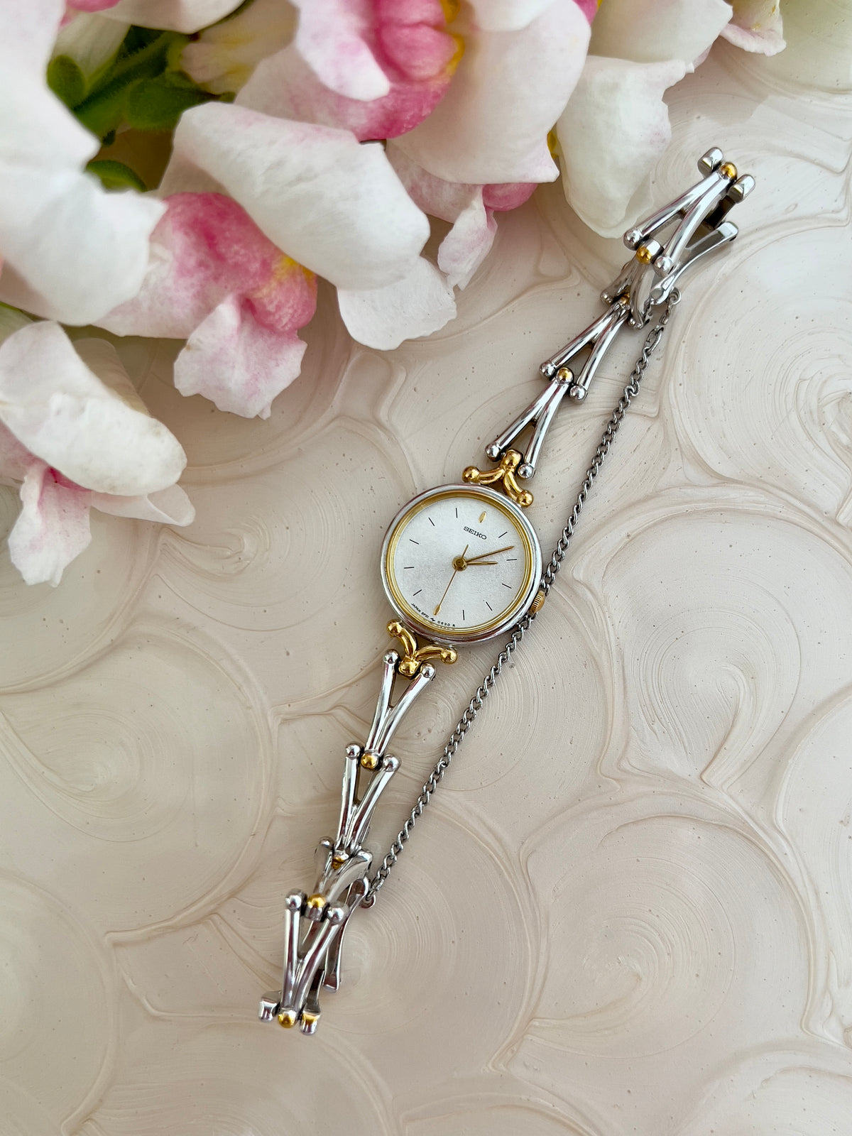 Seiko Two Tone Women’s Watch with White Dial and Sculpted Bracelet — front view of case and bracelet.