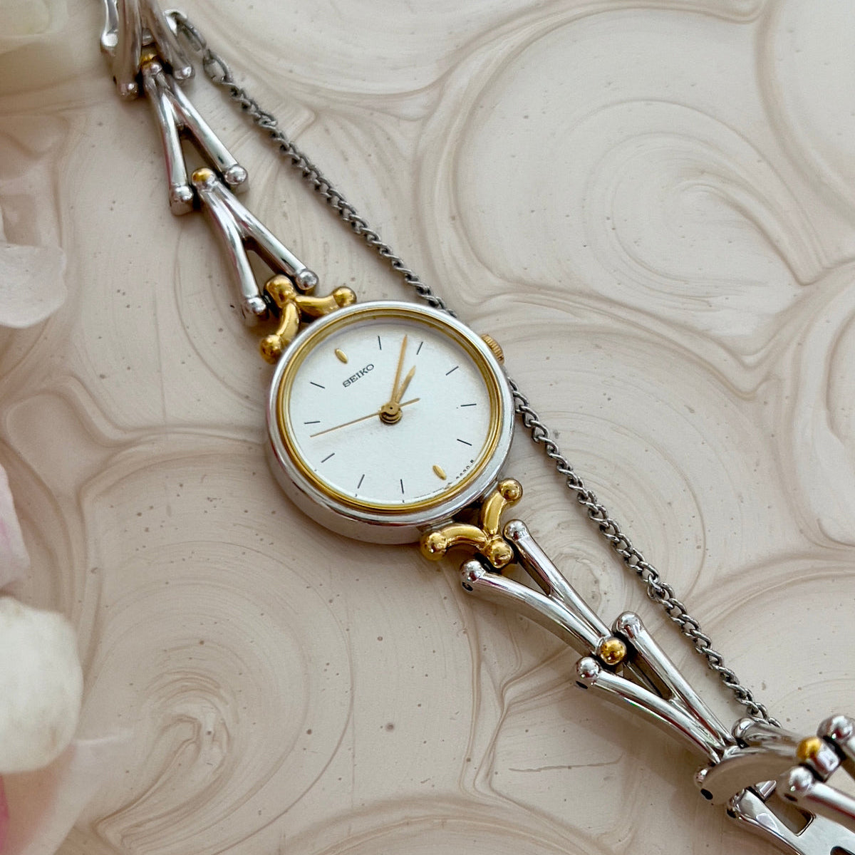 Seiko Two Tone Women’s Watch with White Dial and Sculpted Bracelet — close view of white dial and sculpted links.