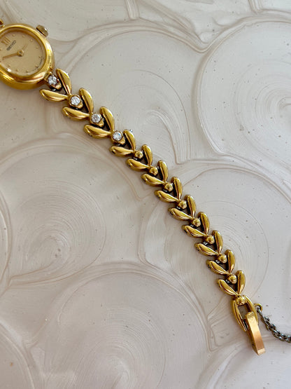 Angled view of the Seiko gold-tone diamond bracelet watch.