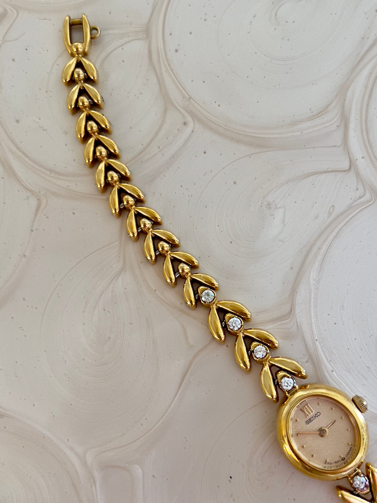 Close-up of the champagne dial on the Seiko gold tennis bracelet watch.