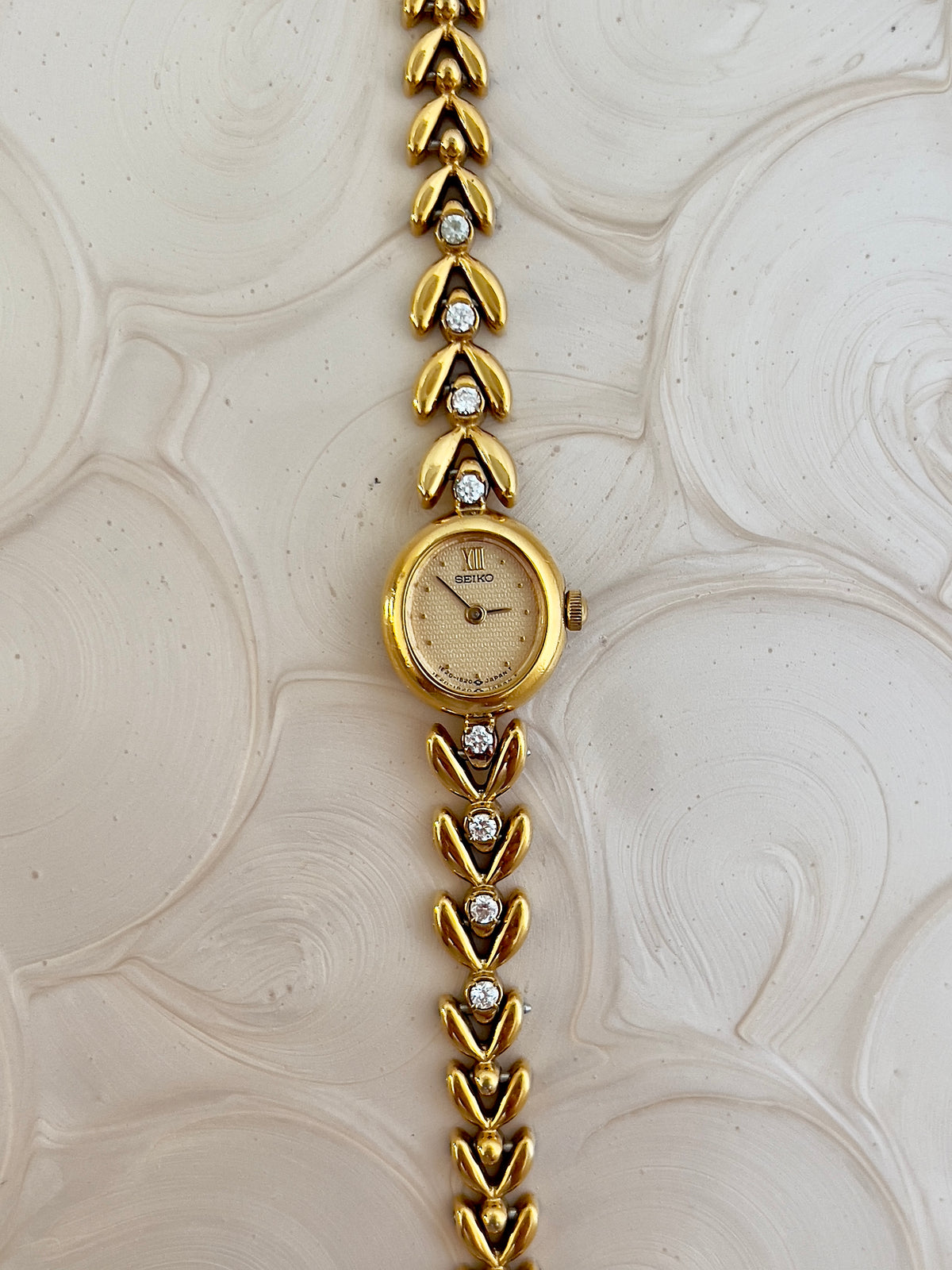 Front view of the Seiko petite oval watch with champagne dial.