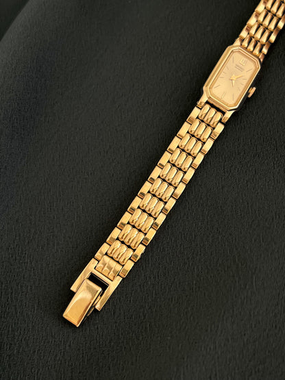 Sculpted gold-tone bracelet and champagne dial detail on Seiko watch