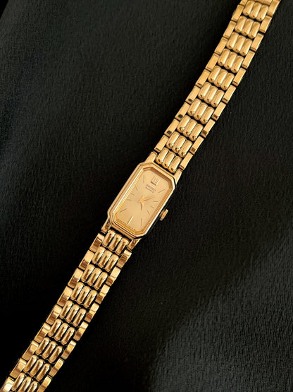 Three-quarter front view of the Seiko gold-tone watch and articulated bracelet