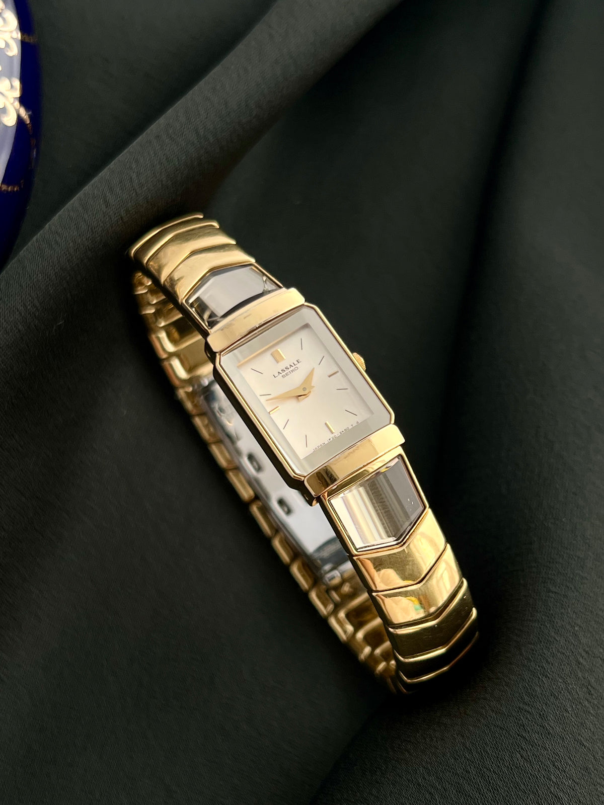 Angled view of the Seiko Lassale 1F20-6C70 showing the champagne dial and segmented gold-tone bracelet