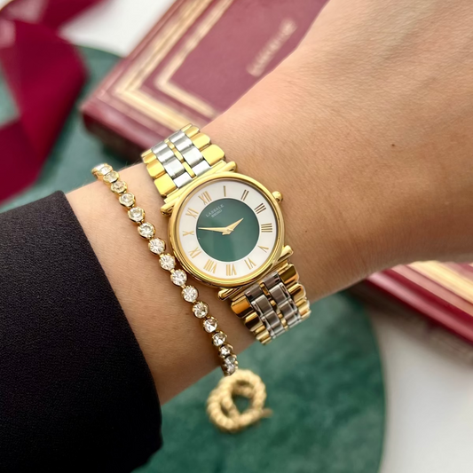 Seiko Lassale emerald-green dial watch with two-tone bracelet worn on a wrist.