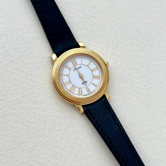 Front view of the Seiko L’espoir gold-tone ladies watch with black leather strap.
