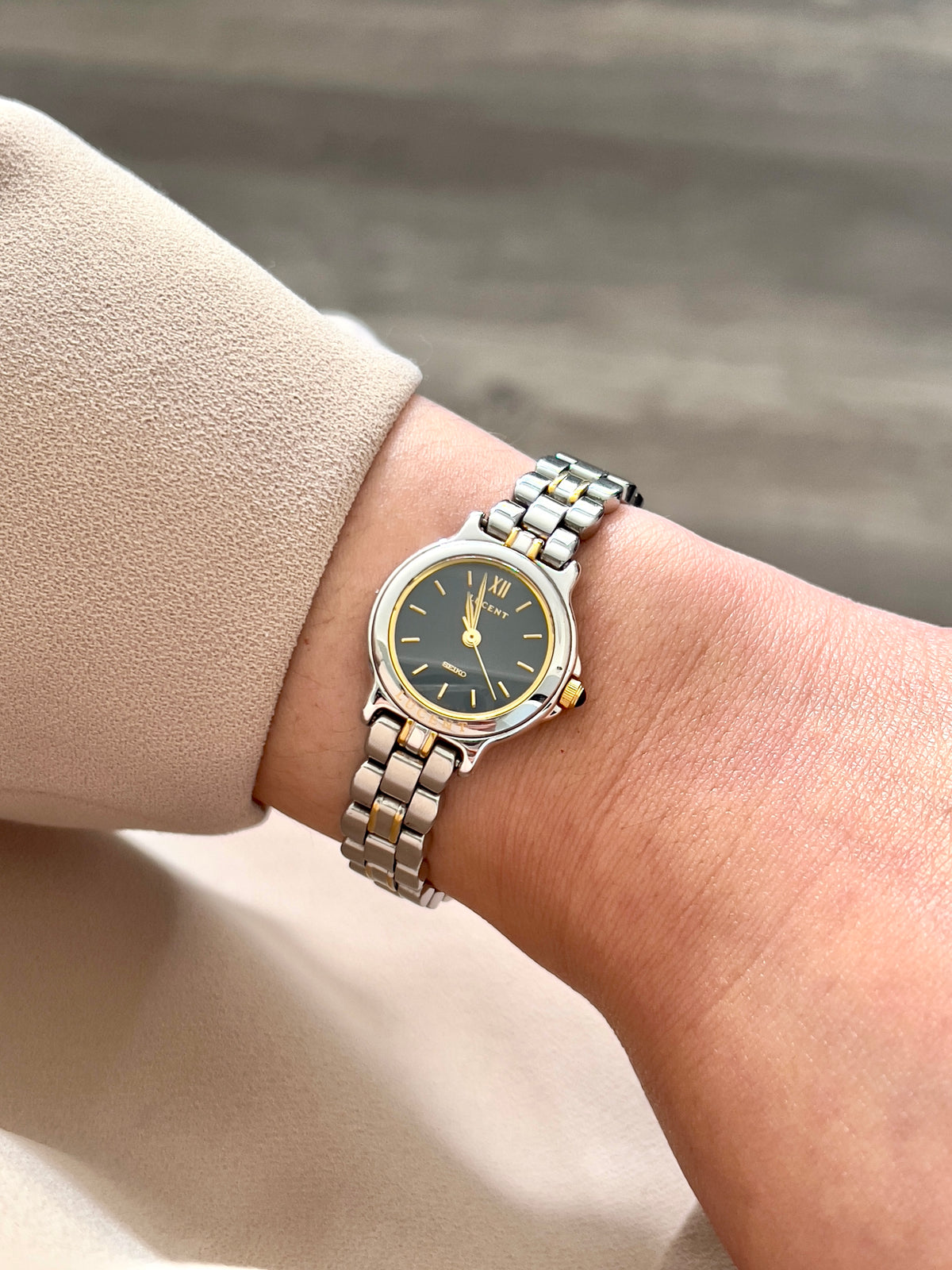Seiko Lucent 1F21-0G90 navy-dial two-tone watch worn on the wrist