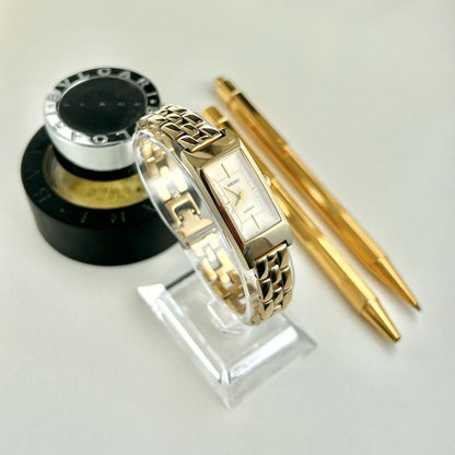 Angled view of the Seiko Lucent 4N21-5370 women’s watch showing its champagne dial and sculptural gold tone bracelet.