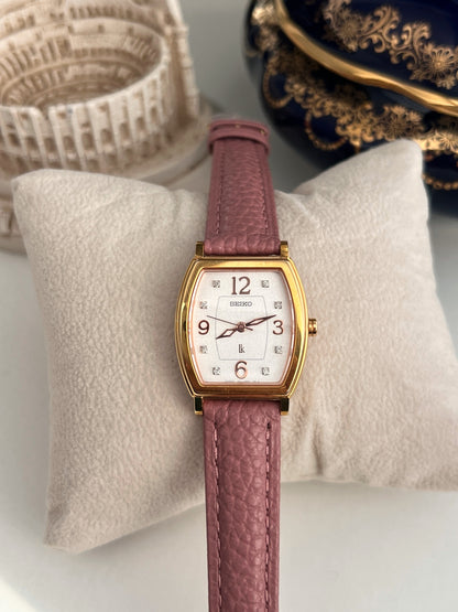 Front of the Seiko Lukia showing eight diamond hour markers, rose coloured Arabic numerals and open hands