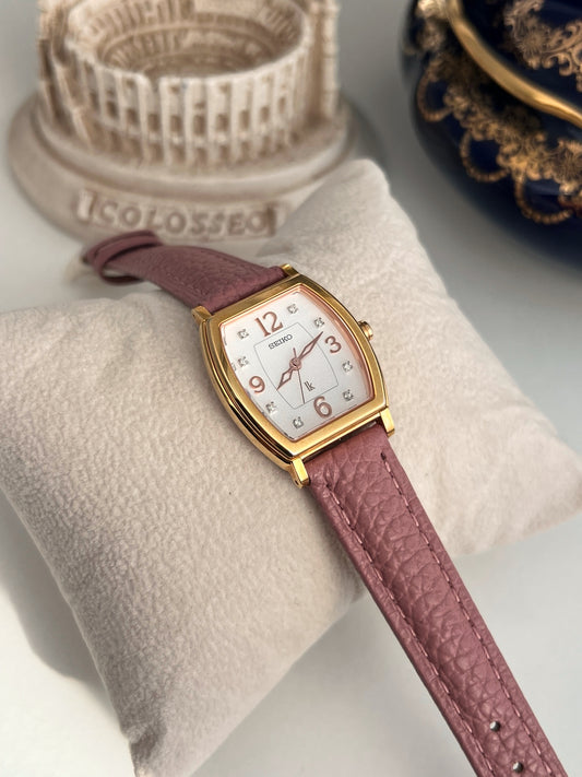 Seiko Lukia women’s watch with a gold tone tonneau case, eight diamond hour markers and muted pink leather strap