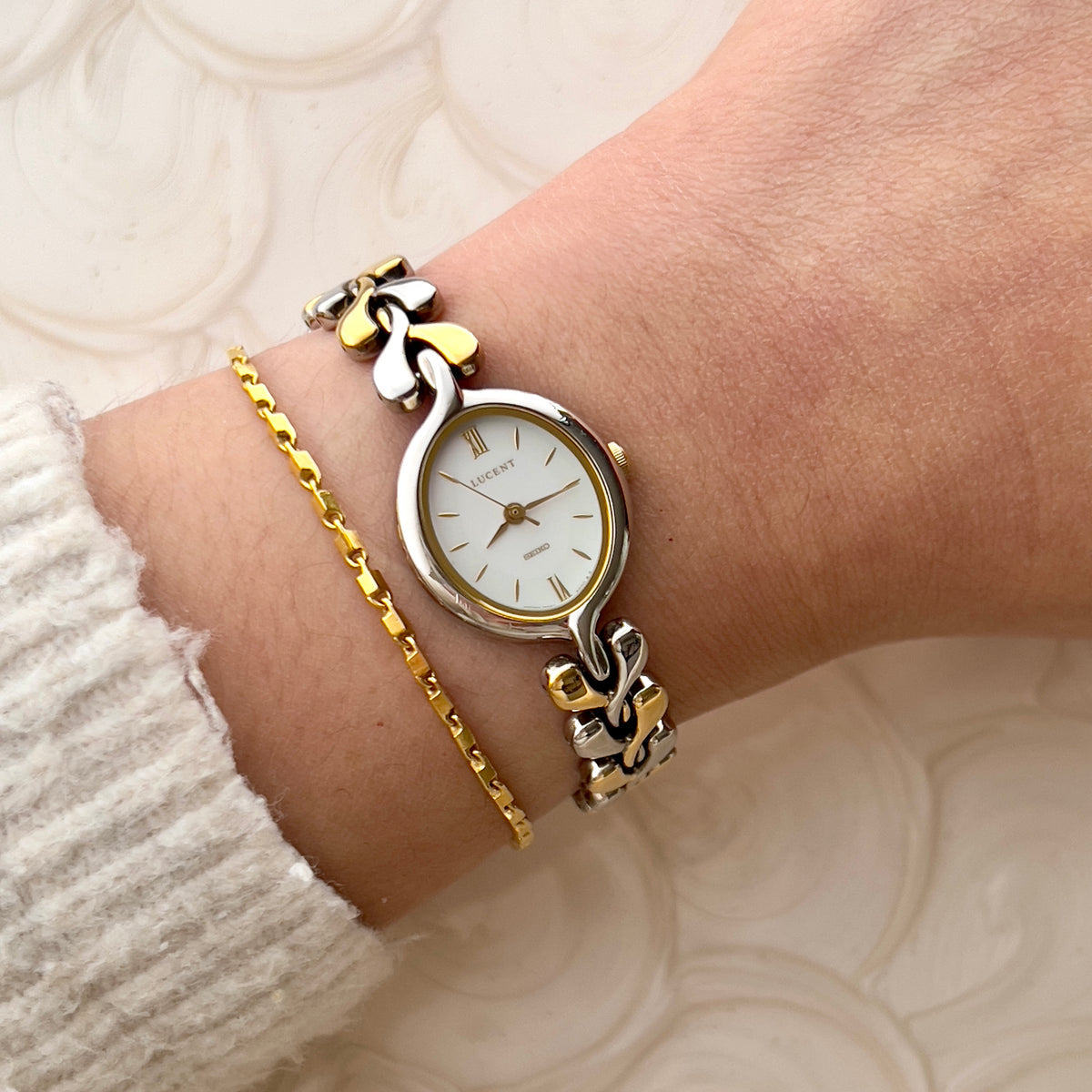 Seiko Lucent two-tone women’s watch with pearlescent dial worn on the wrist