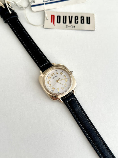 Seiko Nouveau 7321-0340 white dial with applied gold Arabic numerals and a finely textured circular bezel.
