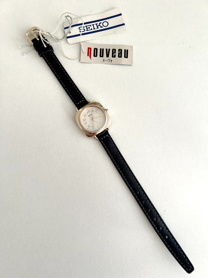 Full-length Seiko Nouveau 7321-0340 with black leather strap, gold tone buckle and Seiko and Nouveau hang tags.