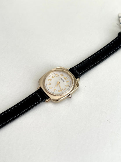 Seiko Nouveau 7321-0340 seen from an angle, showing the loop lugs, fluted crown and stitched black leather strap.