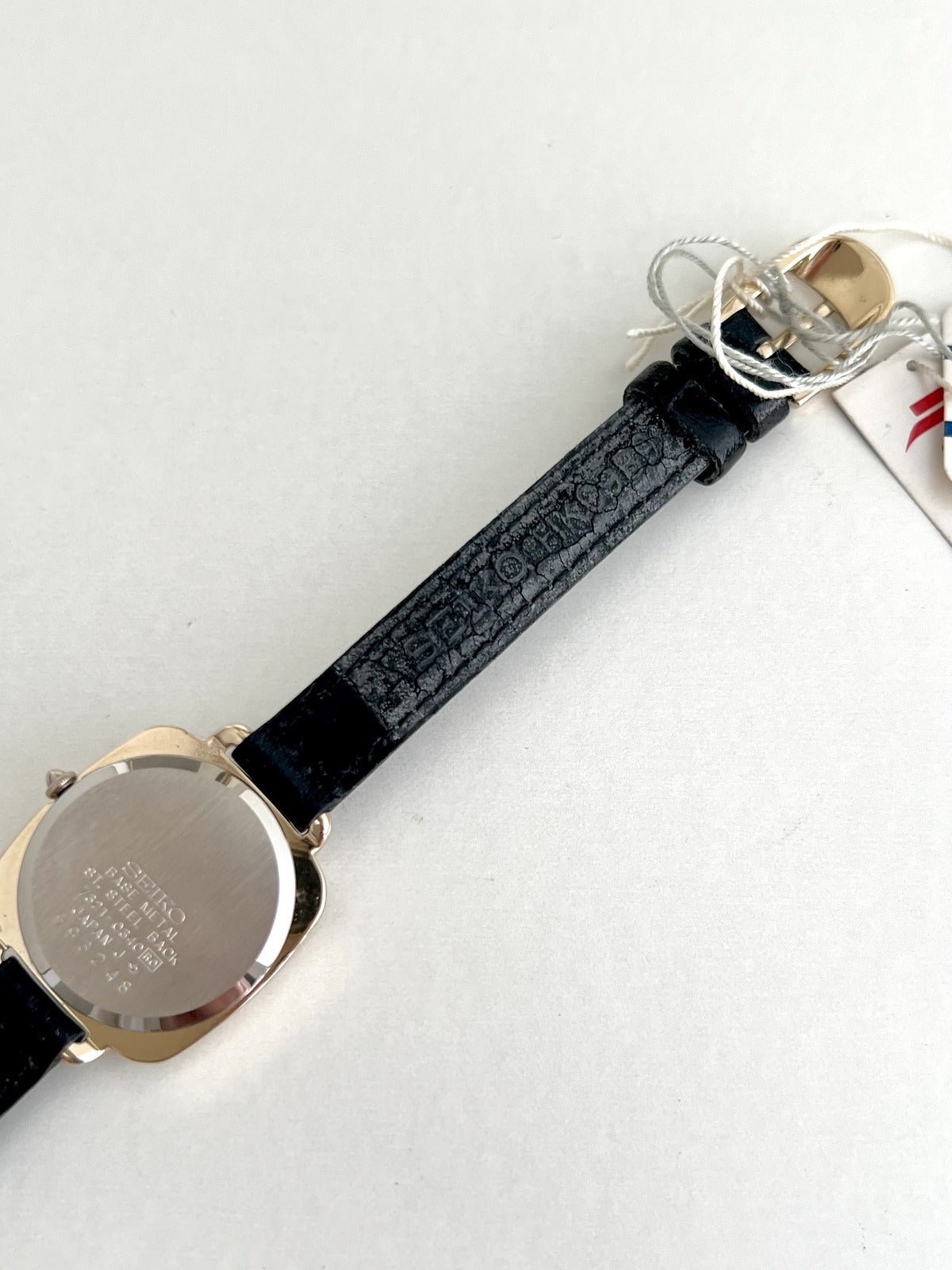 Seiko Nouveau 7321-0340 caseback with serial 593248 and Seiko marking on the leather strap underside.