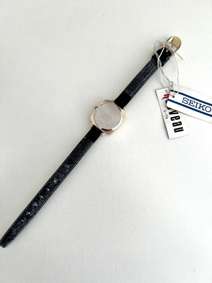 Rear view of the Seiko Nouveau 7321-0340 with stainless steel caseback, Seiko-signed leather strap and attached hang tags.