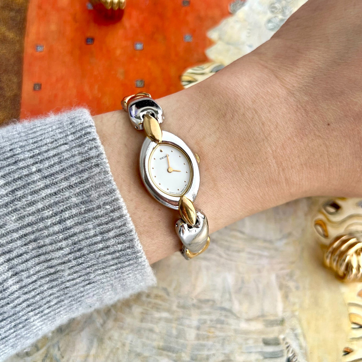 Seiko white oval dial watch with sculpted two tone bracelet pictured on a 15cm circumference wrist