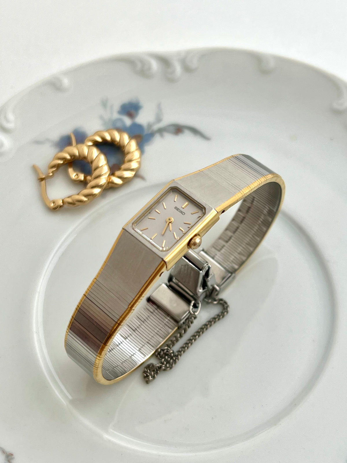 Angled view of the Seiko integrated rectangular case and ribbon bracelet.