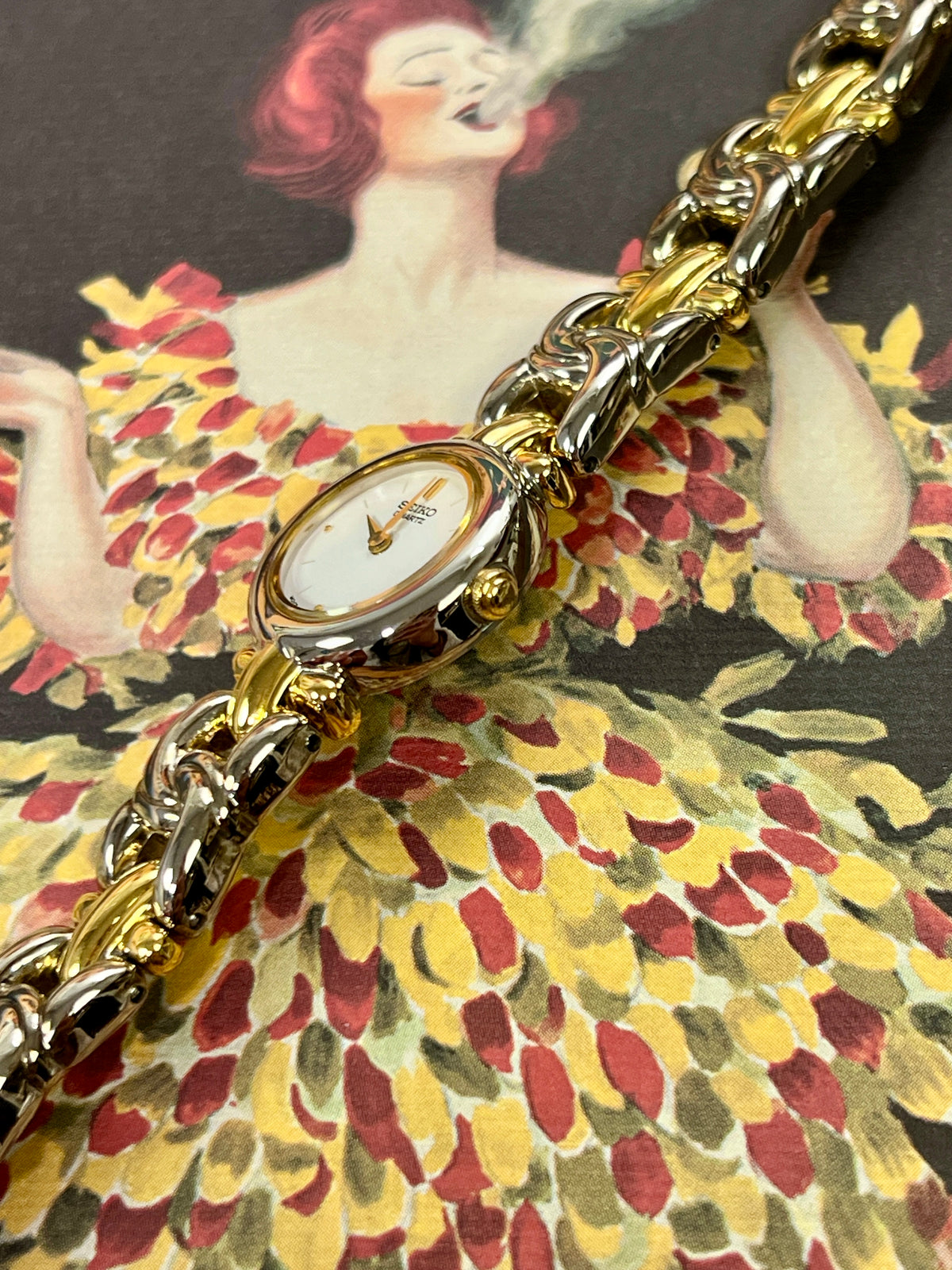 Seiko two-tone ladies watch with textured dial and sculptural steel and gold bracelet.
