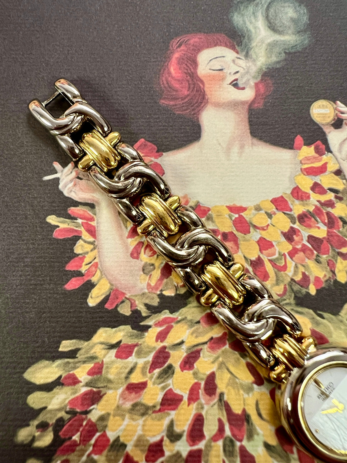 Gold-tone crown and rounded case of the Seiko petite two-tone watch.