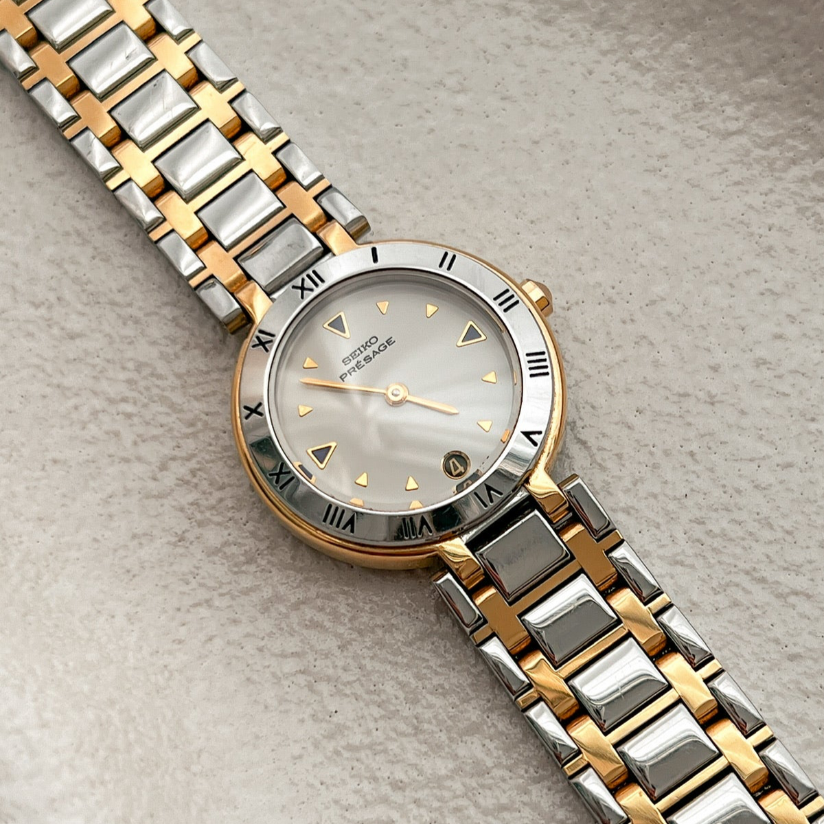 Seiko Presage Roman Bezel Two Tone Women’s Watch featuring silver sunray dial and integrated two tone bracelet; vintage watch product image 1.