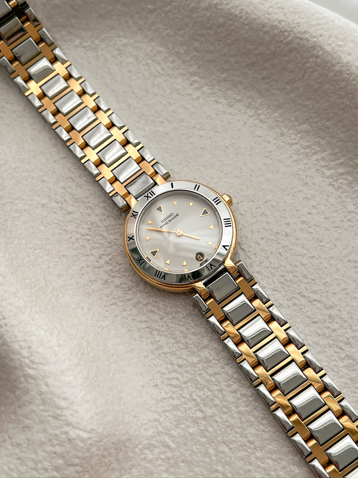 Seiko Presage Roman Bezel Two Tone Women’s Watch featuring silver sunray dial and integrated two tone bracelet; vintage watch product image 2.