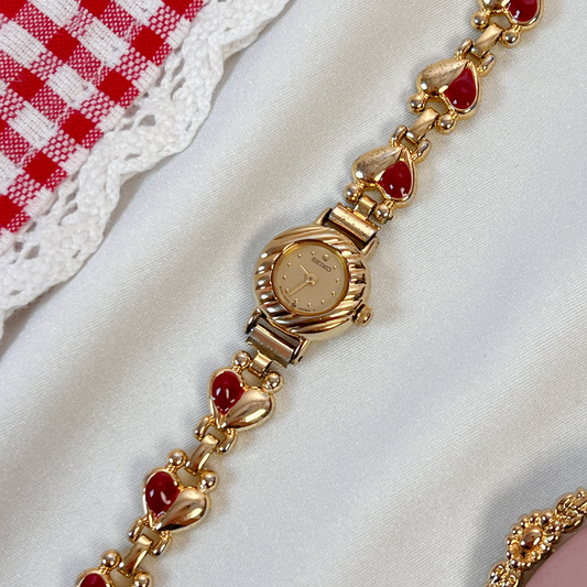 Seiko Rare Petite Watch with Love Heart Bracelet featuring gold dial; vintage watch product image 1.
