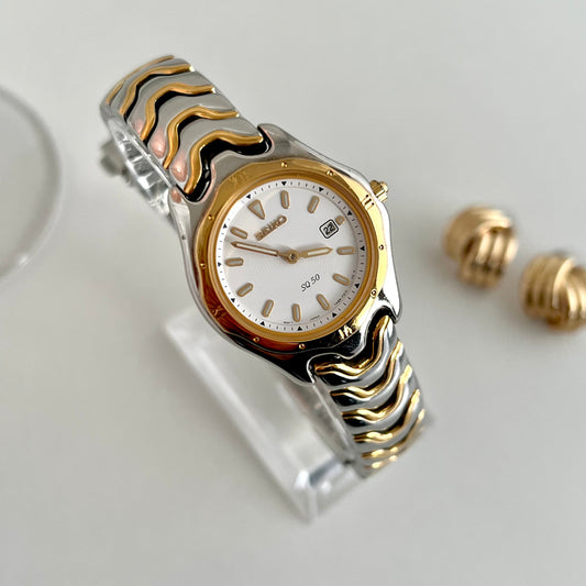 Seiko SQ50 two tone wave bracelet women’s watch with pale dial and date window